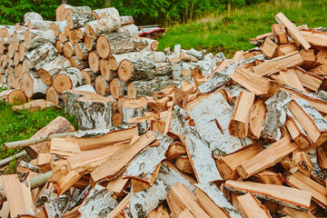 Background of a stack of split logs in a woodpile for use as domestic heating in winter