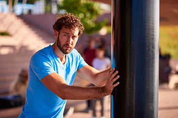 Man stretching and exercising in urban surroundings.