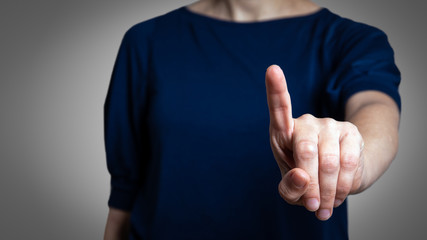 Woman with pointing to something or touching a touch screen