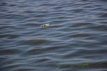 Green water in the Dnieper. Trash floating in the river. Background like texture..