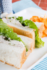 white bread with tuna spread and romaine lettuce served with cheddar potato chips