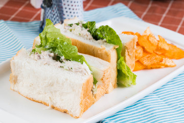 white bread with tuna spread and romaine lettuce served with cheddar potato chips