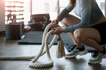 Beautiful sunlight goes through the window. Sportive young woman have fitness day in the gym at...