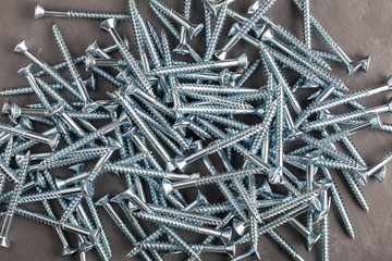 Screws metal steel on grey slate background