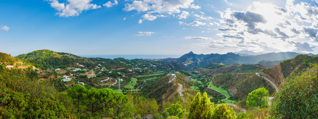 Fototapeta na wymiar Mountain landscape on a sunny day. Panoramic view from the serpentines of the highway A-397 Ronda - Malaga. Spain, Andalusia