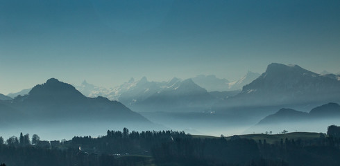 Morning fog above the Luzern lake with mountains
