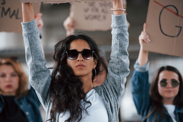 Luxury sunglasses. Group of feminist women have protest for their rights outdoors