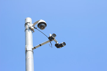 Security camera on blue sky background