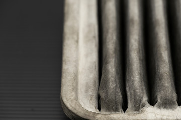 Old dirty automotive engine air filter isolated on black background