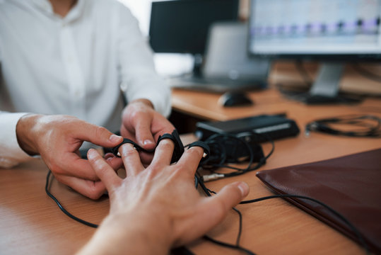 Giving the hand. Preparation for the polygraph test. Conception of the lie detector
