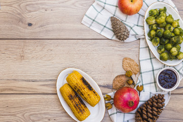 Grilled corns with brussels sprouts on table