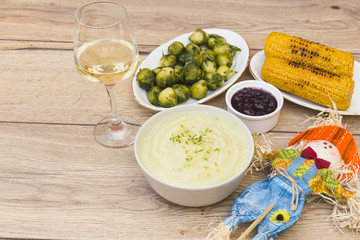 Grilled corns with glass of wine on table