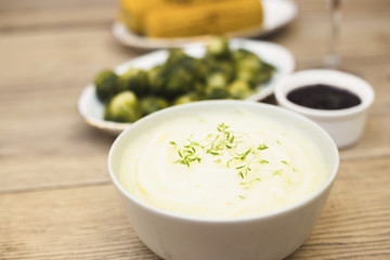 Potato puree in bowl on table