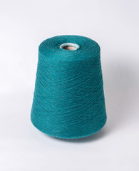 bobbin of yarn on a white background. Side view.Textile reel on isolated white background.