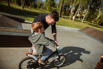 Father Learning his son to ride a bicycle	