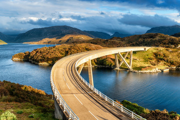 The curved Kylesku Bridge in Scotland - Powered by Adobe
