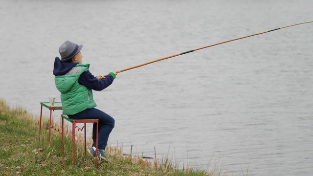 Child plays the fisherman catching big fish