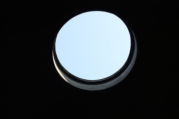 A round hole in which the sky is visible