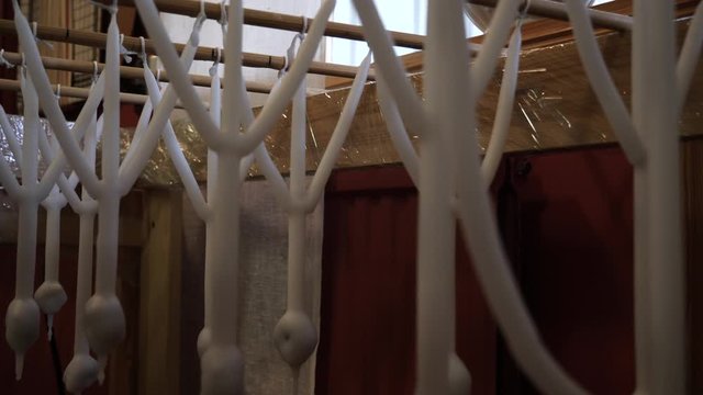 Homemade candles for Christmas hangs in a row