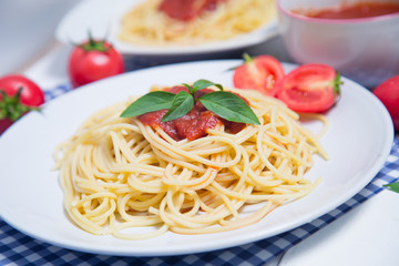 Spaghetti pasta with and tomato sauce on wood background