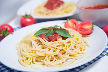 Spaghetti pasta with and tomato sauce on wood background