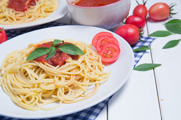 Spaghetti pasta with and tomato sauce on wood background