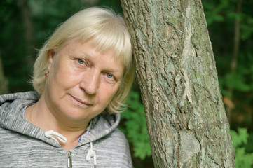 Portrait of a beautiful middle-aged woman outdoors. Selective focus.