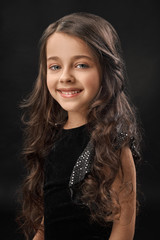 Fototapeta premium Portrait of girl laughing on black isolated background