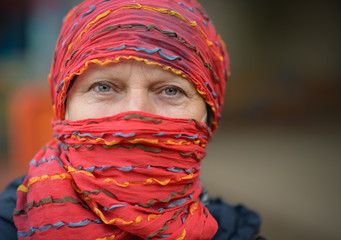 Portrait of a beautiful middle-aged woman in red scarf.