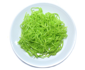 green noodles on dish isolated on white background