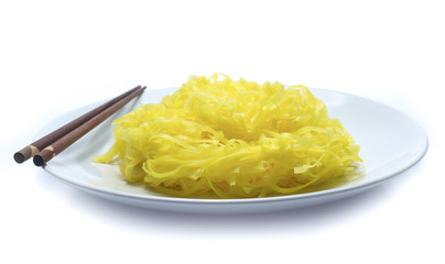 yellow noodles on dish isolated on white background