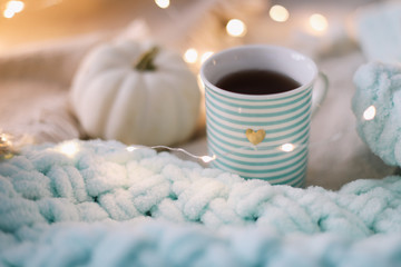 Autumn still life. A cup, dried leaves, book and pumpkin. Hygge lifestyle, cozy autumn mood. Flat lay, thanksgiving background