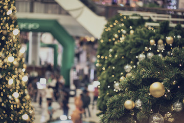 Obraz premium bauble hanging from a decorated Christmas tree. Retro filter effect