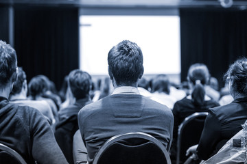 Business and entrepreneurship symposium. Speaker giving a talk at business meeting. Audience in...