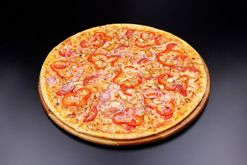 Pizza Margherita on darken background in an italian restaurant.