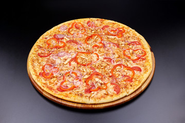 Pizza Margherita on darken background in an italian restaurant.