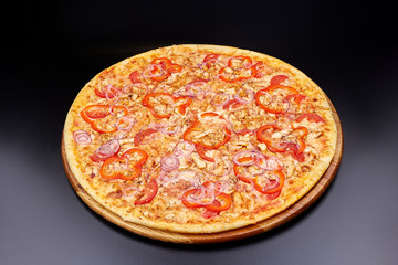 Pizza Margherita on darken background in an italian restaurant.