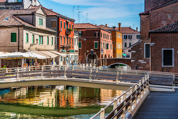 Colorful houses with channel and bridge in Italy