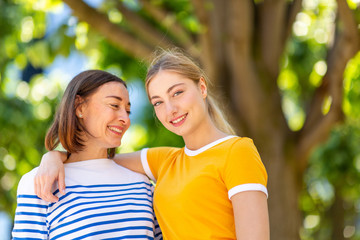 Close up happy mother and daughter standing outdoors