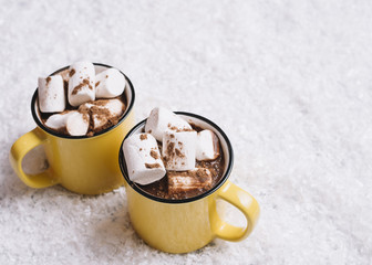 Cups with marshmallows between snow
