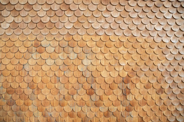 Traditional facade cladding with brown roof shingles