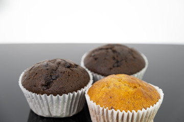Delicious of banana and chocolate chip cupcake isolated on black background