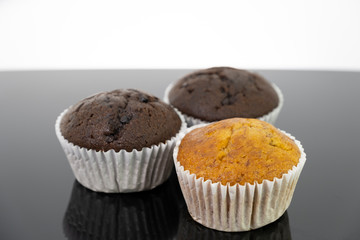 Delicious of banana and chocolate chip cupcake isolated on black background