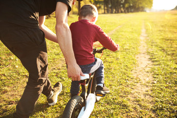 The father teaches son how to cycling