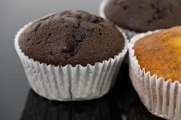 Delicious of banana and chocolate chip cupcake isolated on black background