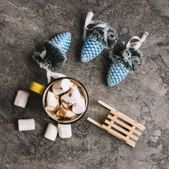 Mug with marshmallows near Christmas toys