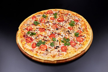 Fresh pizza with BBQ sauce on wooden cutting board. isolated on dark background.