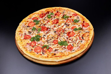 Fresh pizza with BBQ sauce on wooden cutting board. isolated on dark background.