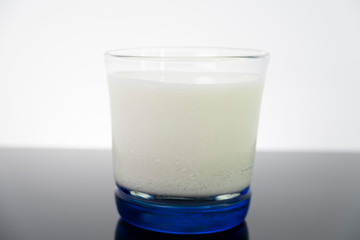 Dairy white milk in the glass isolated on black background