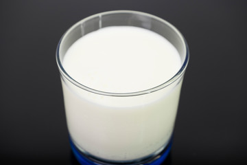 Dairy white milk in the glass isolated on black background